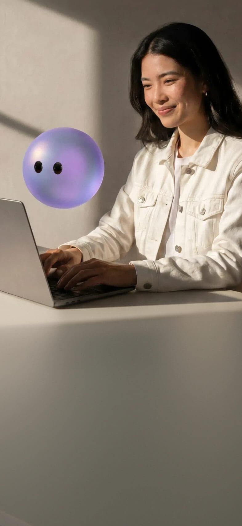 Customer service agent working at a laptop beside a Lyro orb